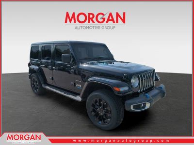 2022 Jeep Wrangler Unlimited Sahara 4xe in Black — front three-quarter view