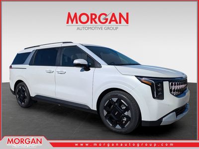 2026 Kia Carnival EX in Snow White Pearl — front three-quarter view
