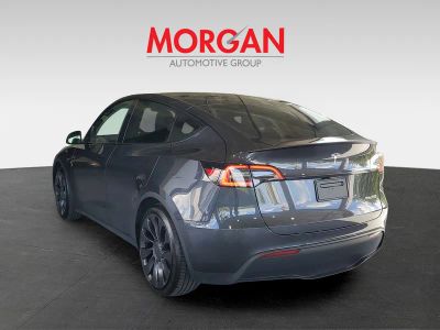 2024 Tesla Model Y — rear three-quarter view
