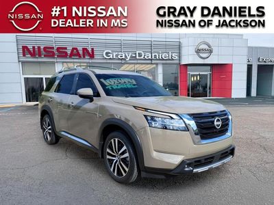2024 Nissan Pathfinder Platinum in Baja Storm — front three-quarter view