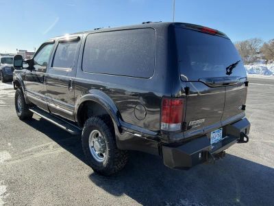 2002 Ford Excursion — rear three-quarter view
