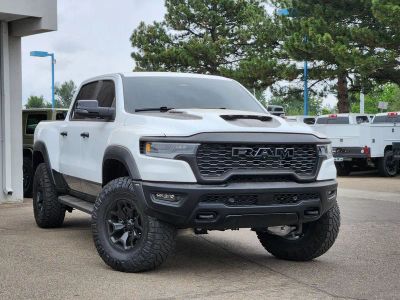 2025 RAM 1500 RHO Crew Cab 4x4 5'7' Box in Bright White Clearcoat — front three-quarter view