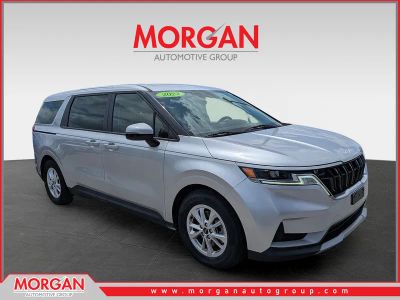 2022 Kia Carnival LXS in Silky Silver — front three-quarter view