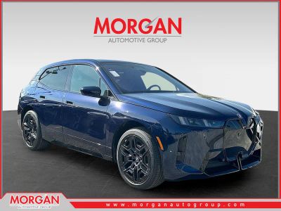2026 BMW iX xDrive45 in Tanzanite Blue II Metallic — front three-quarter view