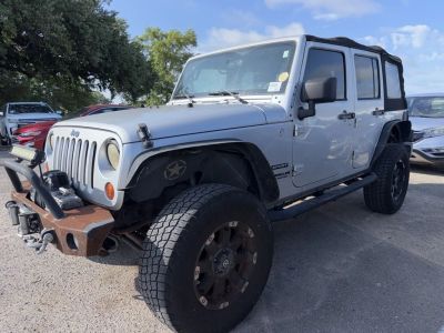 2012 Jeep Wrangler Unlimited Sport in Silver — front three-quarter view