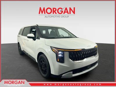 2026 Kia Carnival LXS in Snow White Pearl — front three-quarter view