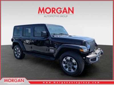 2021 Jeep Wrangler Unlimited Sahara in Black — front three-quarter view