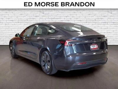 2025 Tesla Model 3 — rear three-quarter view