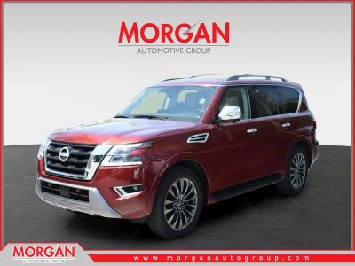 2024 Nissan Armada Platinum in Coulis Red Pearl — front three-quarter view
