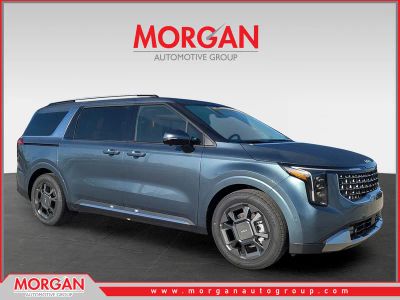 2026 Kia Carnival SX in Astra Blue — front three-quarter view