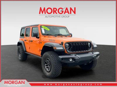 2025 Jeep Wrangler Willys in Orange — front three-quarter view