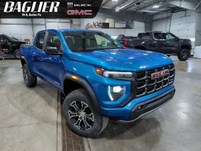 2023 GMC Canyon AT4 in Dynamic Blue Metallic — front three-quarter view