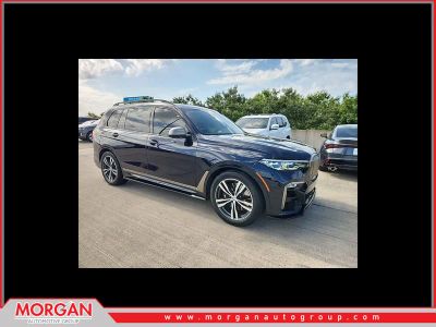 2022 BMW X7 M50i in Carbon Black Metallic — front three-quarter view