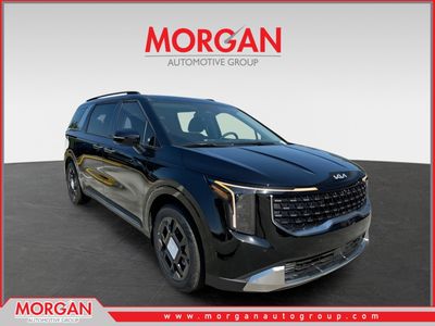 2026 Kia Carnival Hybrid SX in Aurora Black Pearl — front three-quarter view
