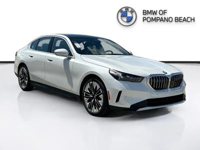 2026 BMW 5 Series 530i in Mineral White Metallic — front three-quarter view