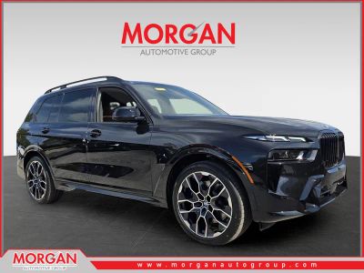 2026 BMW X7 M60i in Black Sapphire Metallic — front three-quarter view