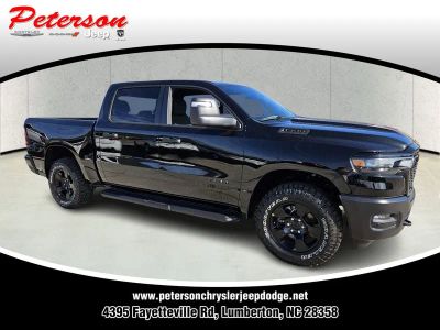 2026 RAM Ram 1500 RAM 1500 WARLOCK CREW CAB 4X4 5'7' BOX in Diamond Black Crystal Pearl-Coat Exterior Paint — front three-quarter view