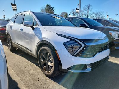 2024 Kia Sportage SX in Glacial White Pearl — front three-quarter view