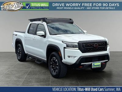 2023 Nissan Frontier PRO-4X in Glacier White — front three-quarter view