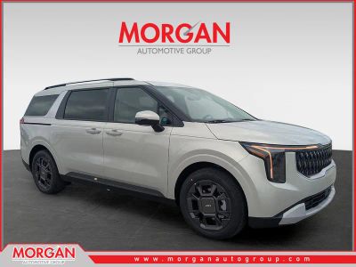 2026 Kia Carnival Hybrid EX in Ivory Silver — front three-quarter view