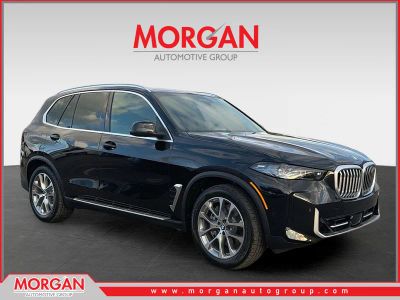 2026 BMW X5 xDrive50e in Black Sapphire Metallic — front three-quarter view