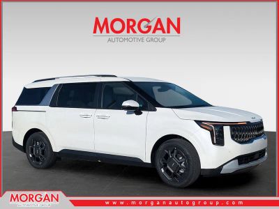 2026 Kia Carnival Hybrid EX in Snow White Pearl — front three-quarter view