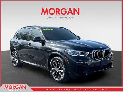 2019 BMW X5 xDrive50i in Black Sapphire Metallic — front three-quarter view