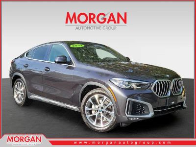 2021 BMW X6 xDrive40i in Dark Graphite Metallic — front three-quarter view