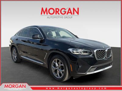 2022 BMW X4 xDrive30i in Jet Black — front three-quarter view