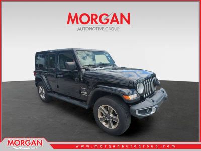 2019 Jeep Wrangler Unlimited Sahara in Black — front three-quarter view