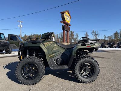 2026 Polaris Sportsman 570 Premium - 40th Anniversary Edition A26SEZ57AB in Treeline Green Metallic — front three-quarter view