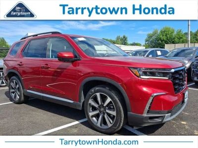 2023 Honda Pilot Elite in Radiant Red Metallic II — front three-quarter view