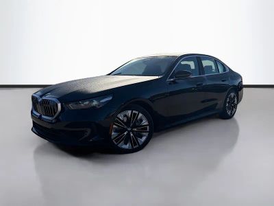 2024 BMW 5 Series 540i xDrive in Black Sapphire Metallic — front three-quarter view
