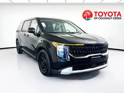 2025 Kia Carnival LXS in Aurora Black Pearl — front three-quarter view