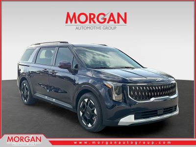 2026 Kia Carnival EX in Deep Chroma Blue — front three-quarter view