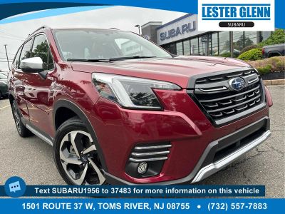 2023 Subaru Forester Touring in Crimson Red Pearl — front three-quarter view