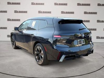 2026 BMW iX — rear three-quarter view