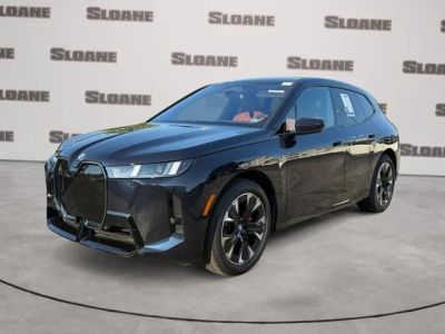 2026 BMW iX xDrive60 in Carbon Black Metallic — front three-quarter view