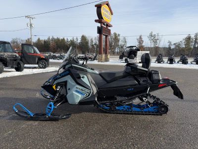 2026 Polaris 650 INDY Adventure 137 ES S26TDE6RS in Hemlock Blue / Black / Velocity Blue — front three-quarter view