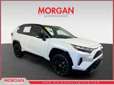 2025 Toyota RAV4 Hybrid XSE in Wind Chill Pearl/Midnight Black Metallic — front three-quarter view