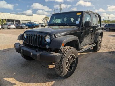 2010 Jeep Wrangler Unlimited Islander in Black — front three-quarter view