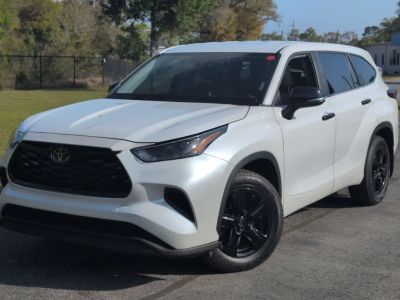 2023 Toyota Highlander L in Beige — front three-quarter view