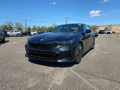 2027 BMW 5 Series 540i xDrive in Black Sapphire Metallic — front three-quarter view