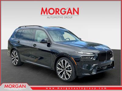 2026 BMW X7 M60i in Black Sapphire Metallic — front three-quarter view