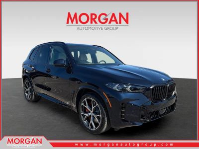 2026 BMW X5 xDrive50e in CARBON BLK MET — front three-quarter view