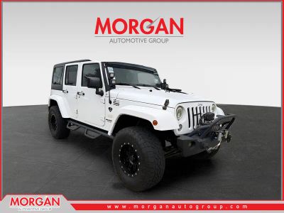 2015 Jeep Wrangler Unlimited Sahara in White — front three-quarter view