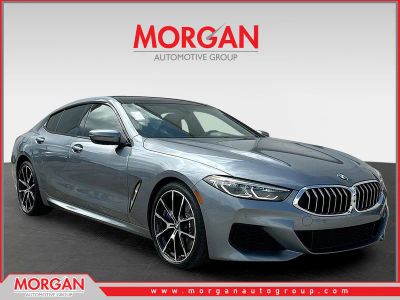 2022 BMW 8 Series 840i in Bluestone Metallic — front three-quarter view