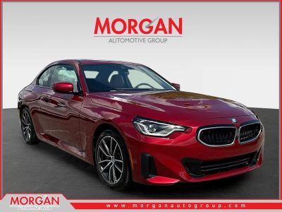 2025 BMW 2 Series 230i in Vegas Red Metallic — front three-quarter view