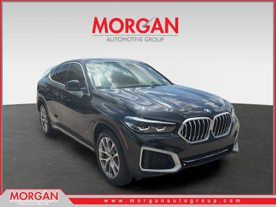 2022 BMW X6 xDrive40i in Black Sapphire Metallic — front three-quarter view