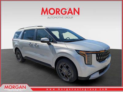 2026 Kia Carnival EX in Ivory Silver — front three-quarter view